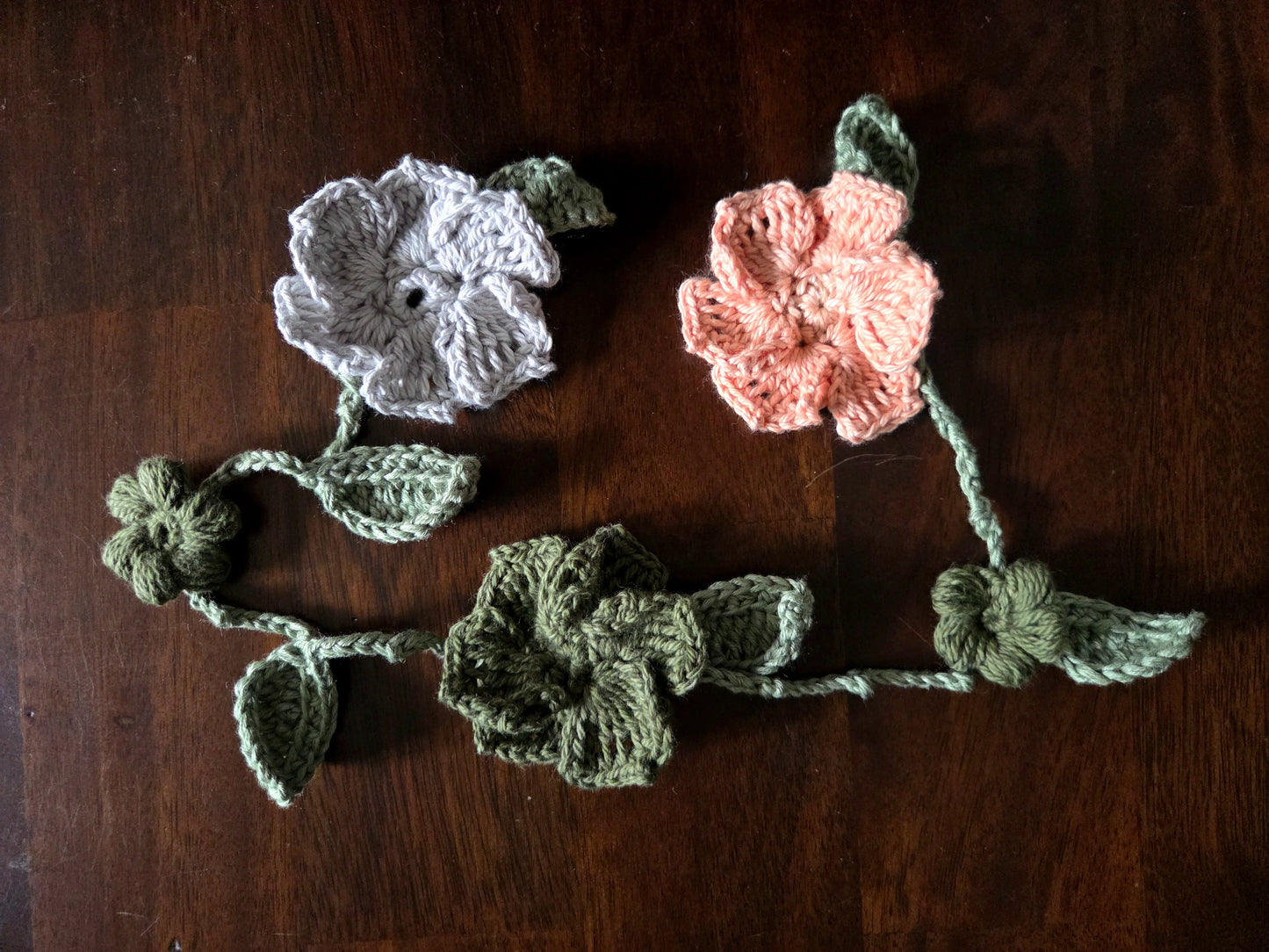 crocheted flowers on a vine garland
