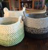 Handmade crochet storage baskets in earth tones on a wooden table