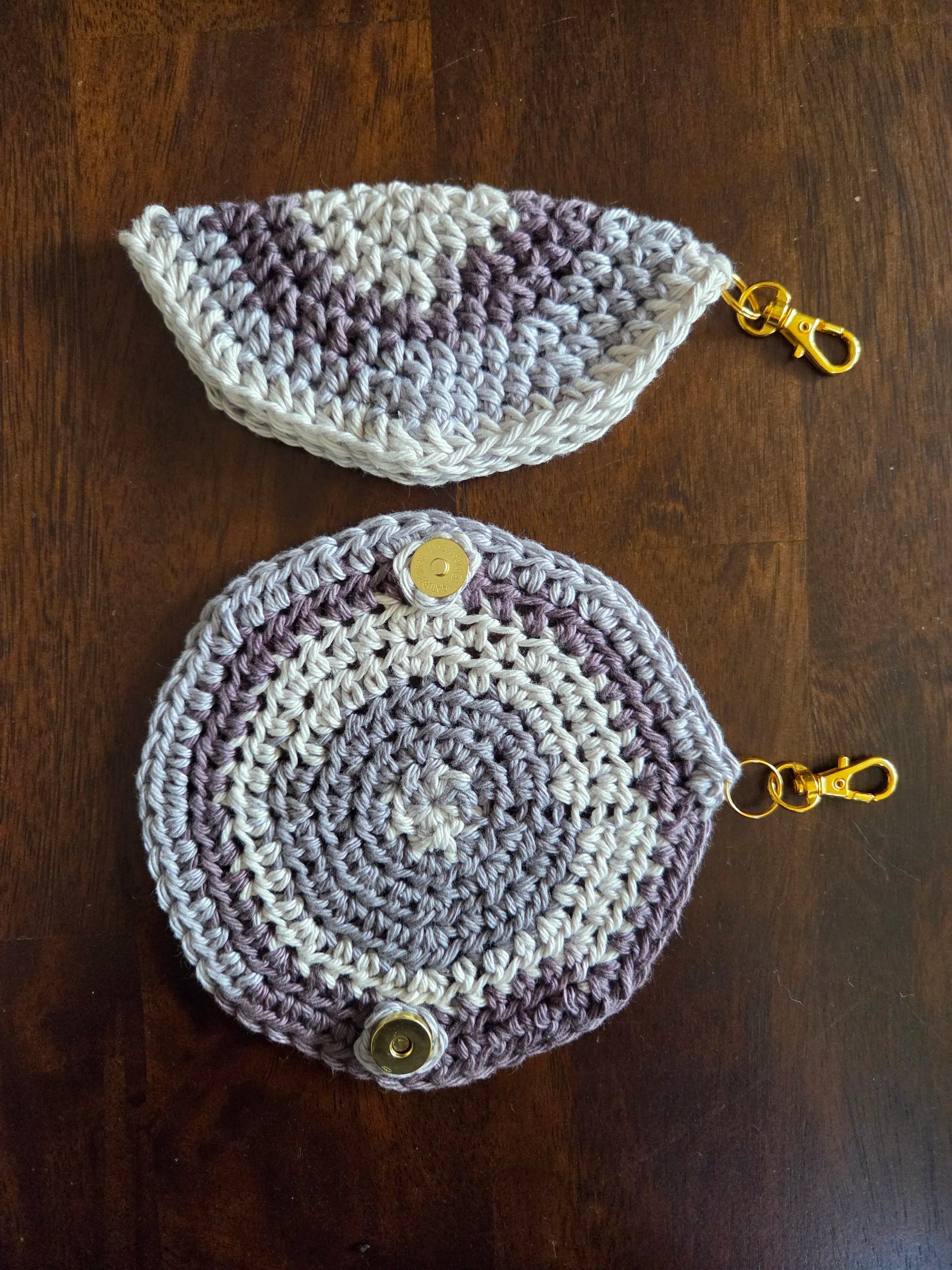 Handcrafted crochet coin purses with gold clasp, round and half-circle, on wood table