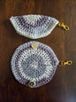 Handcrafted crochet coin purses with gold clasp, round and half-circle, on wood table