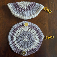Handcrafted crochet coin purses with gold clasp, round and half-circle, on wood table