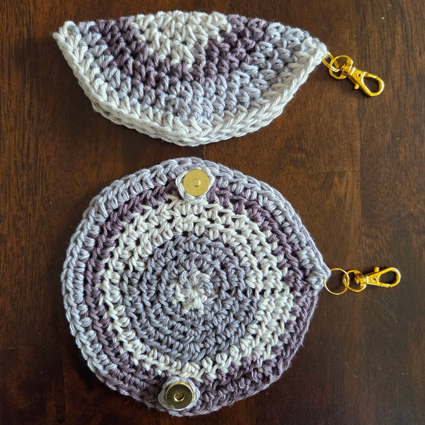 Handcrafted crochet coin purses with gold clasp, round and half-circle, on wood table