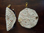 Handmade crochet eyeglass case with clasp, beige and speckled yarn, on wood surface