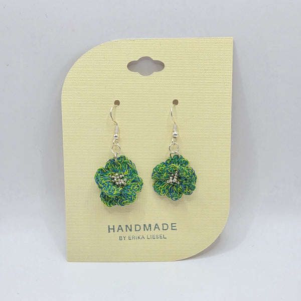 Handmade crochet flower earrings with green and blue yarn, featuring silver beads and hooks