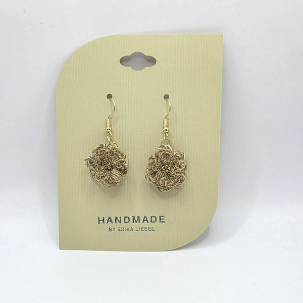 Handmade crochet flower earrings on beige card, gold hooks, cozy artisan design