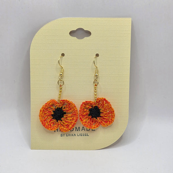 Handmade crochet poppy earrings with orange and yellow petals, black centers, gold hooks