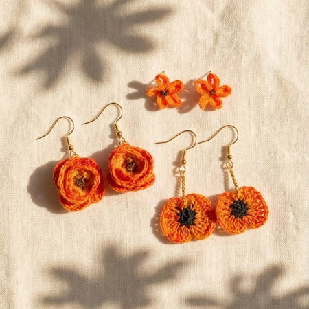 Handmade crochet flower earrings in vibrant orange, perfect for cozy, creative gifting.