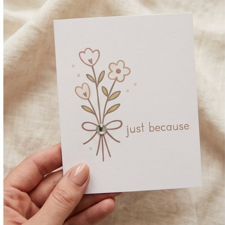 Handheld greeting card with floral design, bow, and 'just because' text for thoughtful gifting