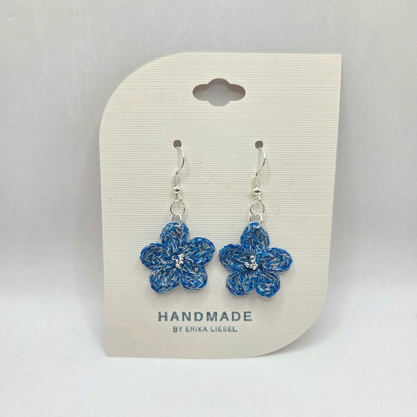 Handmade blue crochet flower earrings with silver beads on display card