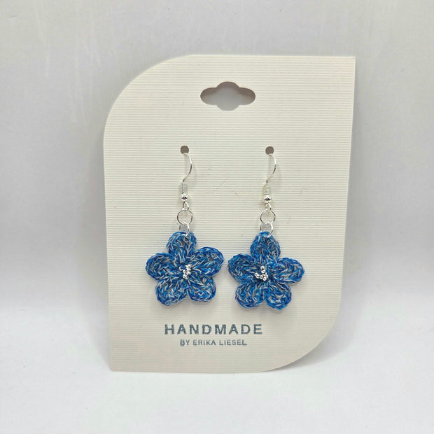 Handmade blue crochet flower earrings with silver beads on display card