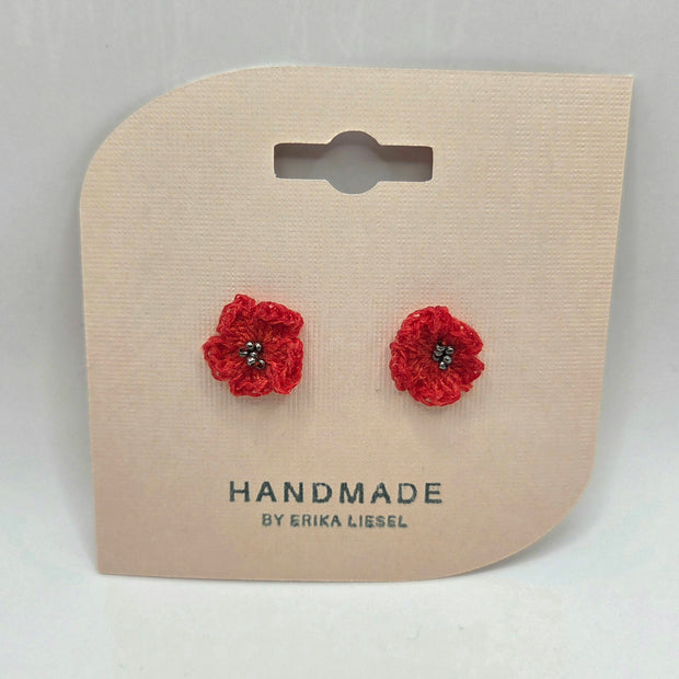 Handmade red crochet flower earrings with bead centers on display card