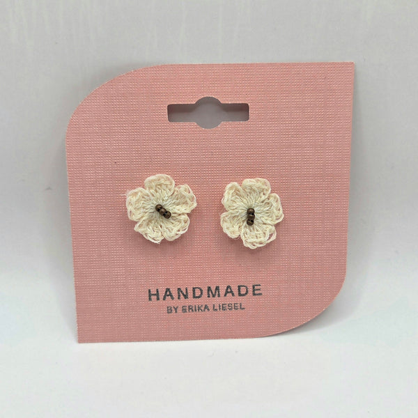 Handmade crochet flower earrings on pink card, cozy and creative gift