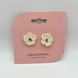 Handmade crochet flower earrings on pink card, cozy and creative gift