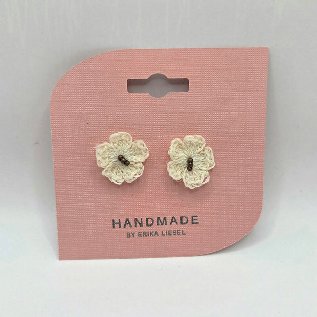 Handmade crochet flower earrings on pink card, cozy and creative gift