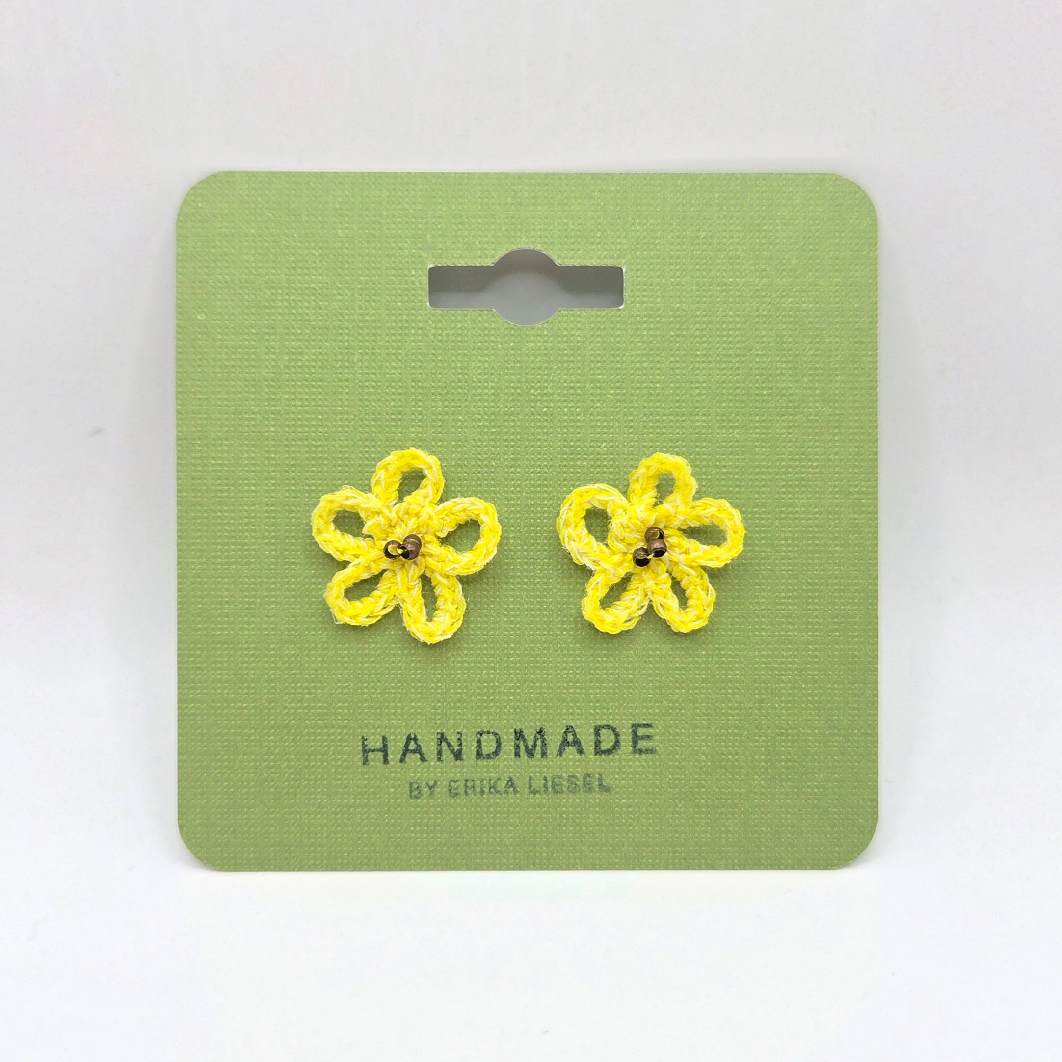 Handmade yellow crochet flower earrings on green card, cozy and creative gift