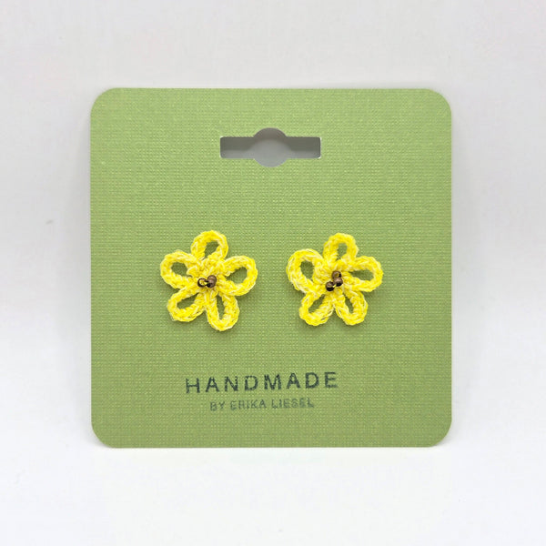 Handmade yellow crochet flower earrings on green card, cozy and creative gift