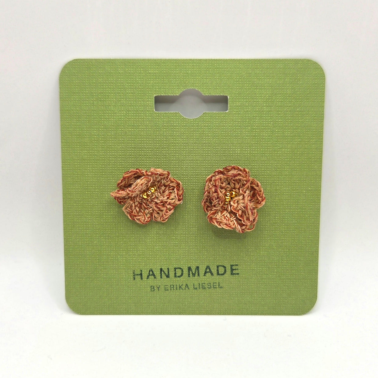 Handmade crochet flower earrings with gold beads on green card