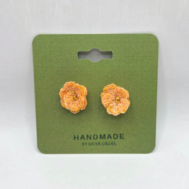 Handmade crochet flower earrings with gold centers on green card