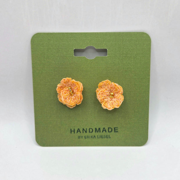 Handmade crochet flower earrings with gold centers on green card