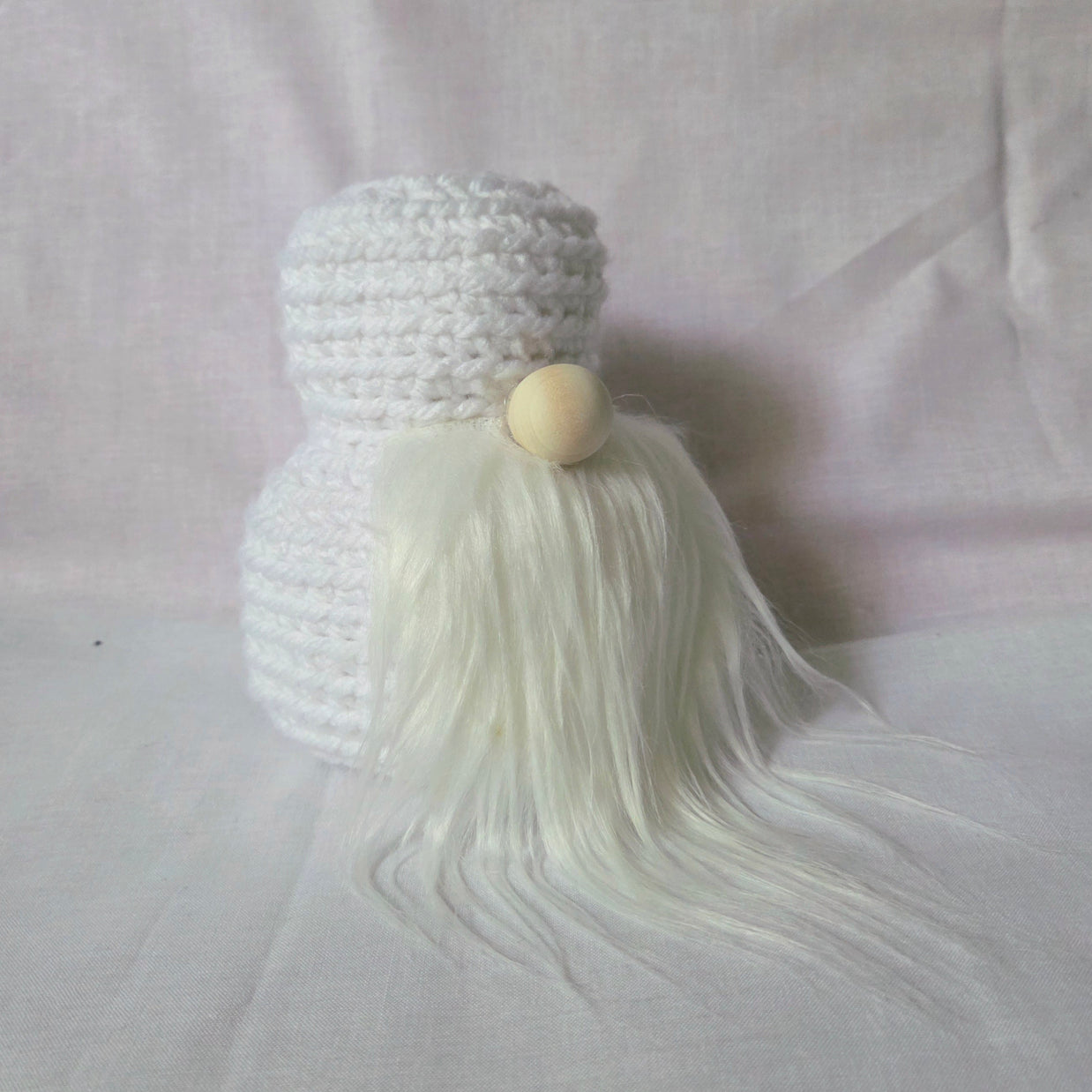 Handmade white crochet gnome with long beard and wooden nose