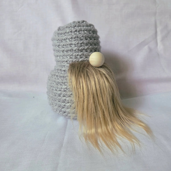 Handmade crochet gnome with gray hat, wooden nose, and blonde hair, cozy home decor