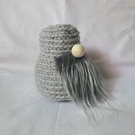 Gray crochet gnome with wooden nose and fluffy beard, handmade cozy decor