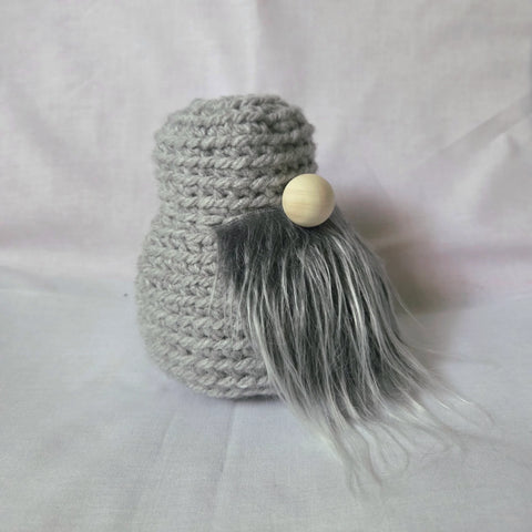 Handmade gray crochet gnome with wooden bead face and long gray beard, cozy home decor