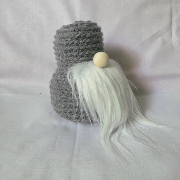 Handmade gray crochet gnome with long white beard and wooden bead nose, cozy home decor