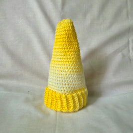 Handmade yellow and white crocheted cone with ruffled base, cozy decorative piece