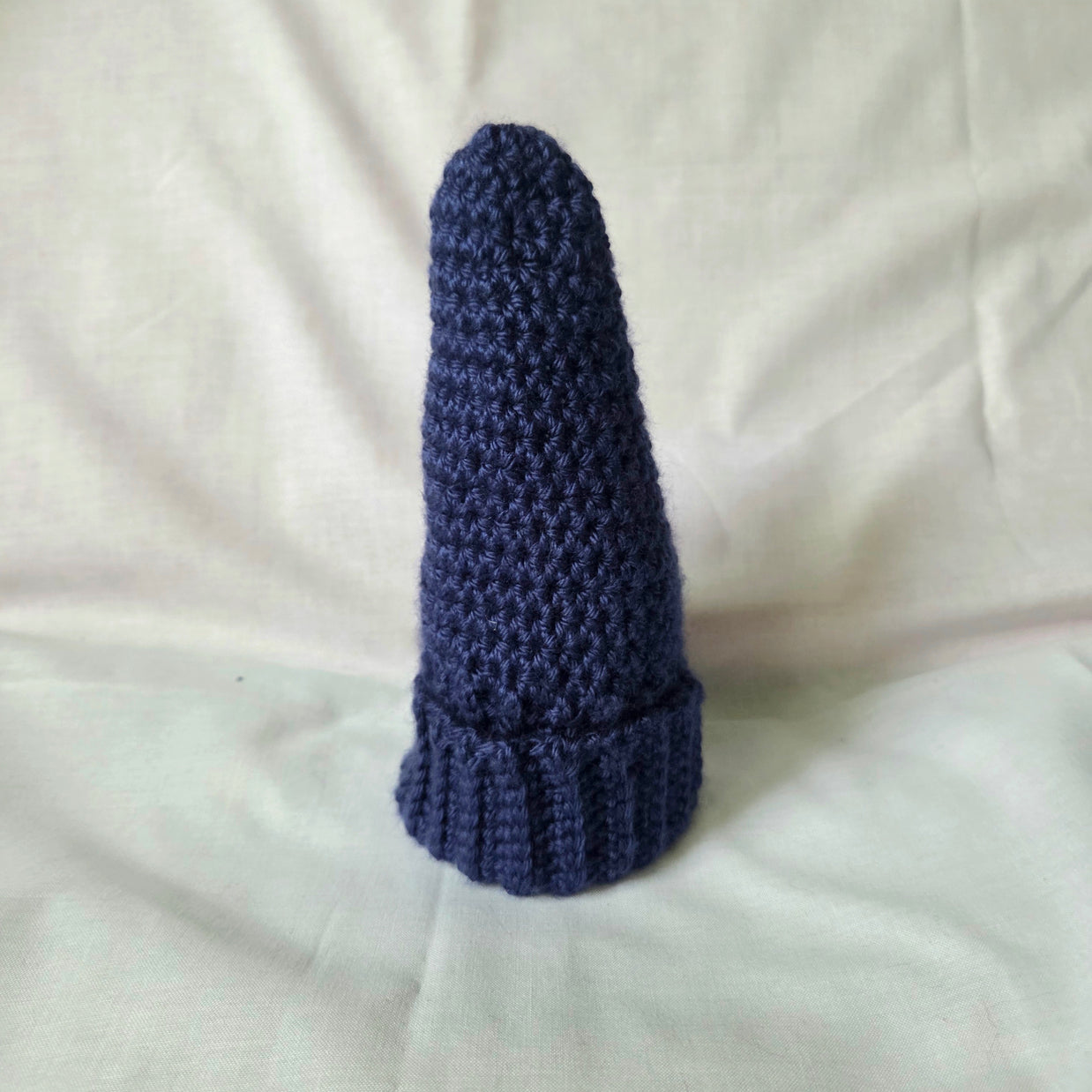 Handmade navy blue crochet hat with ribbed brim, cozy and stylish winter accessory