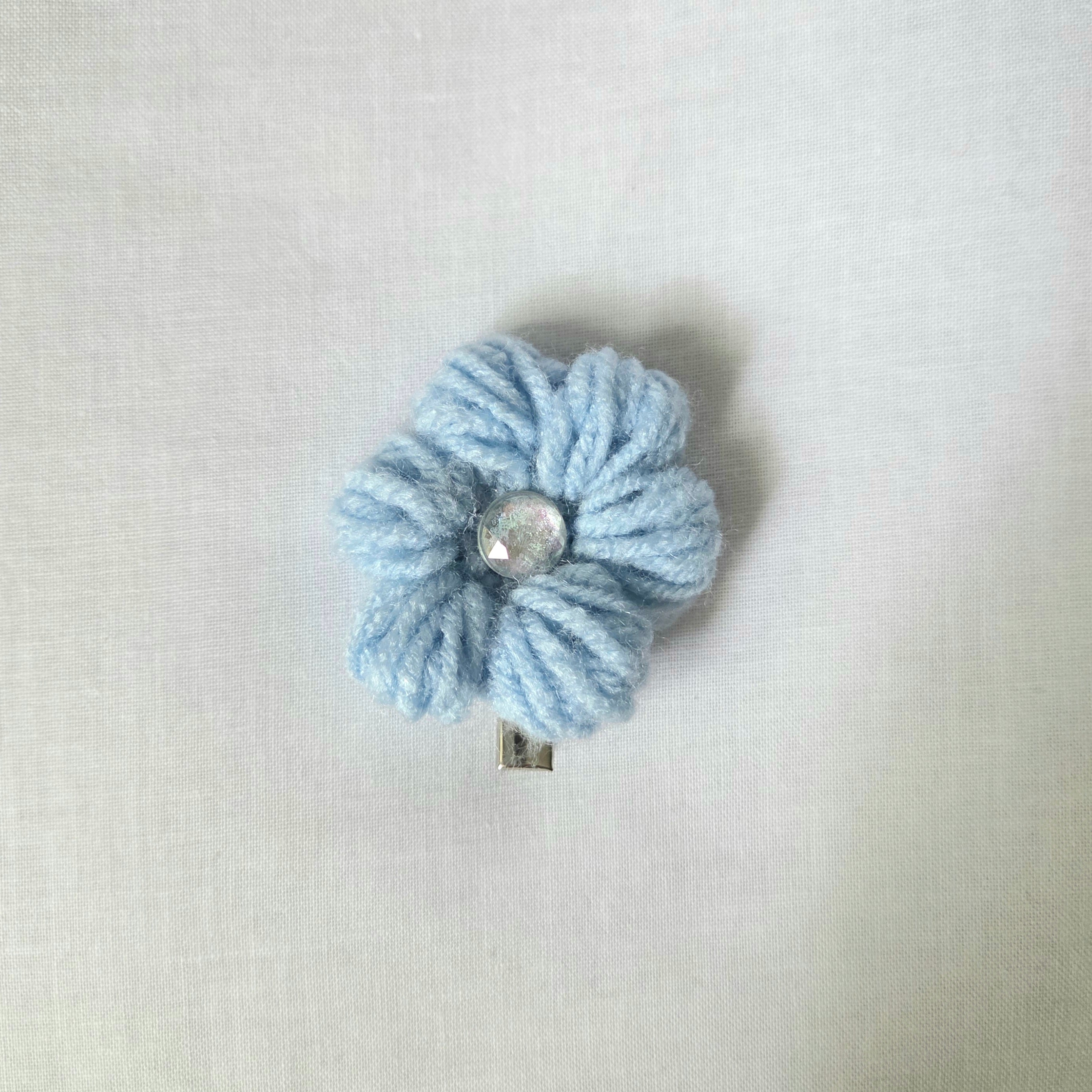 Light blue crocheted flower hair clip with shiny center