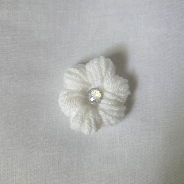 Handmade white crochet flower with sparkling center, cozy and creative design