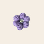 Handmade purple crochet flower with iridescent gem center, cozy craft gift