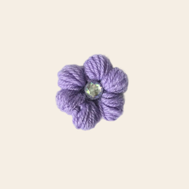 Handmade lavender crochet flower pin with sparkling gem center, cozy craft gift
