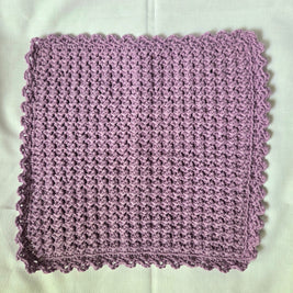 Handmade lavender crochet dishcloth with scalloped edge, cozy kitchen textile