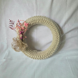 Handmade crochet wreath with dried flowers and twine accent, cozy home decor