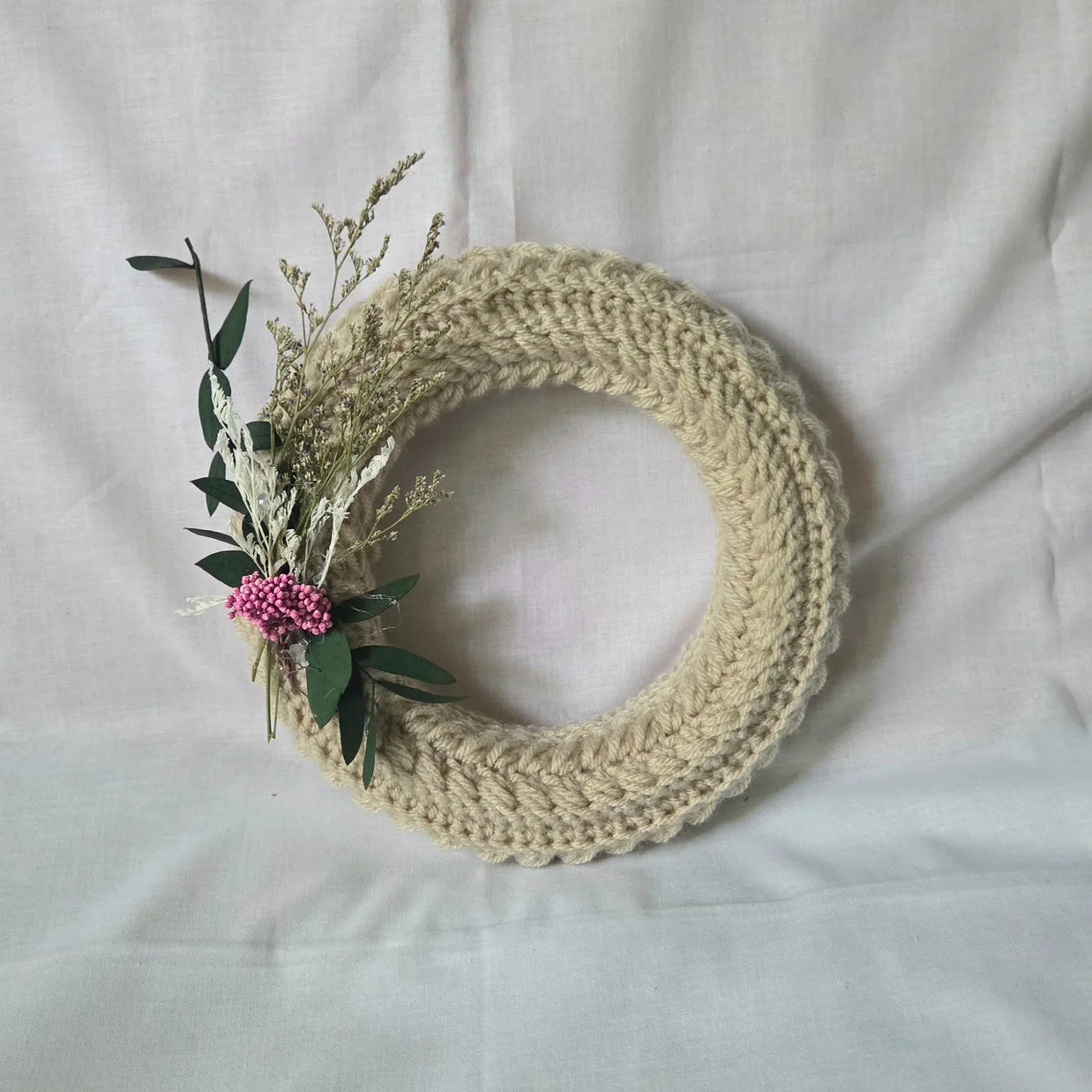Handmade crochet wreath with dried flowers and greenery, cozy home decor