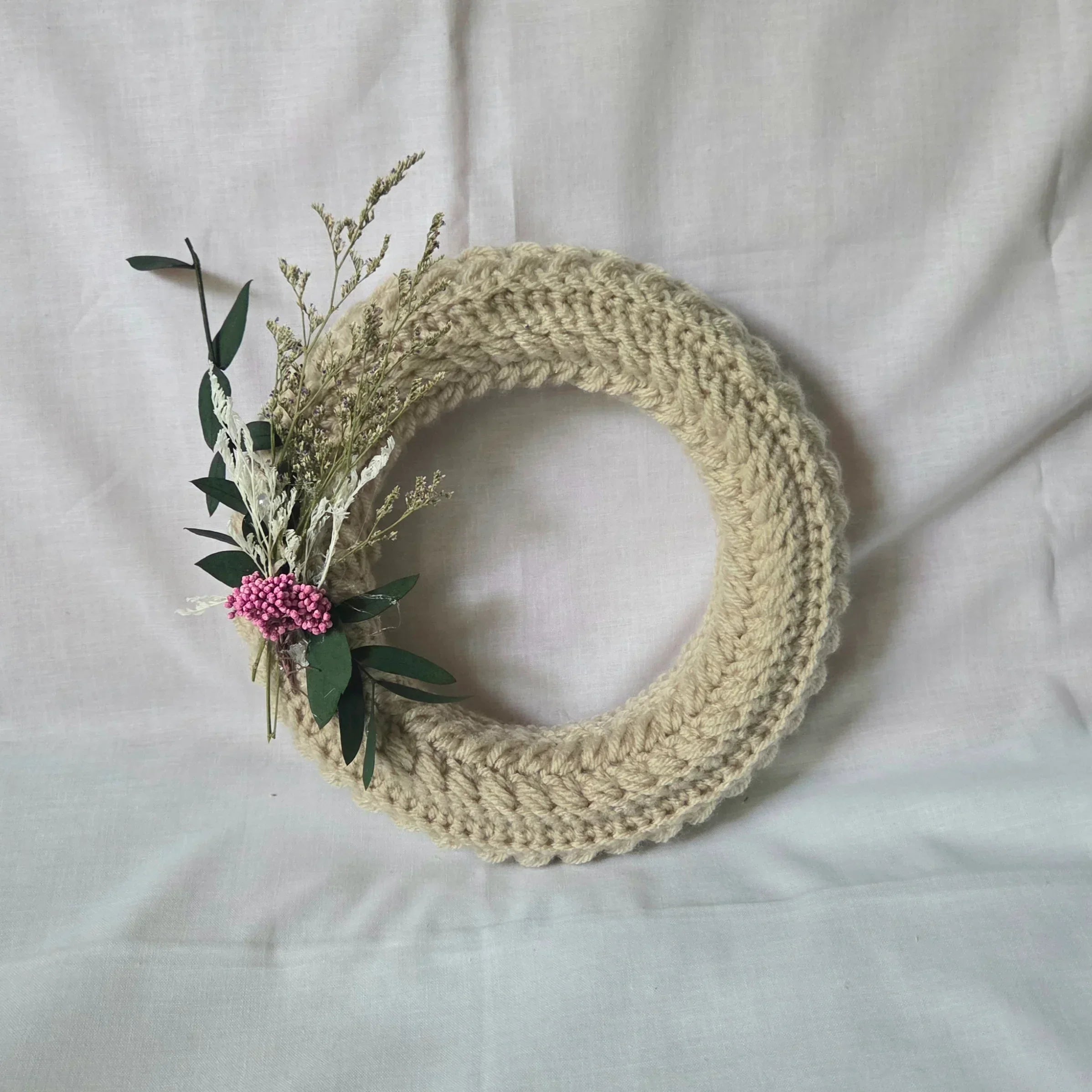 Handmade crochet wreath with dried flowers and greenery, cozy home decor