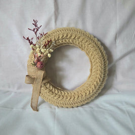 Handmade crochet wreath with dried flowers and burlap ribbon, cozy home decor