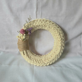 Handmade crochet wreath with dried flowers and burlap accent, cozy home decor