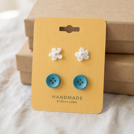Handmade crochet flower and button earrings on yellow card, cozy gift idea