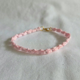 Delicate pink crochet bracelet with gold clasp, handmade for everyday comfort and style.