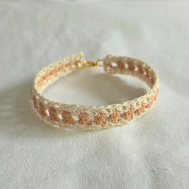 Handmade crochet bracelet with cream and peach pattern, gold clasp, cozy boho accessory