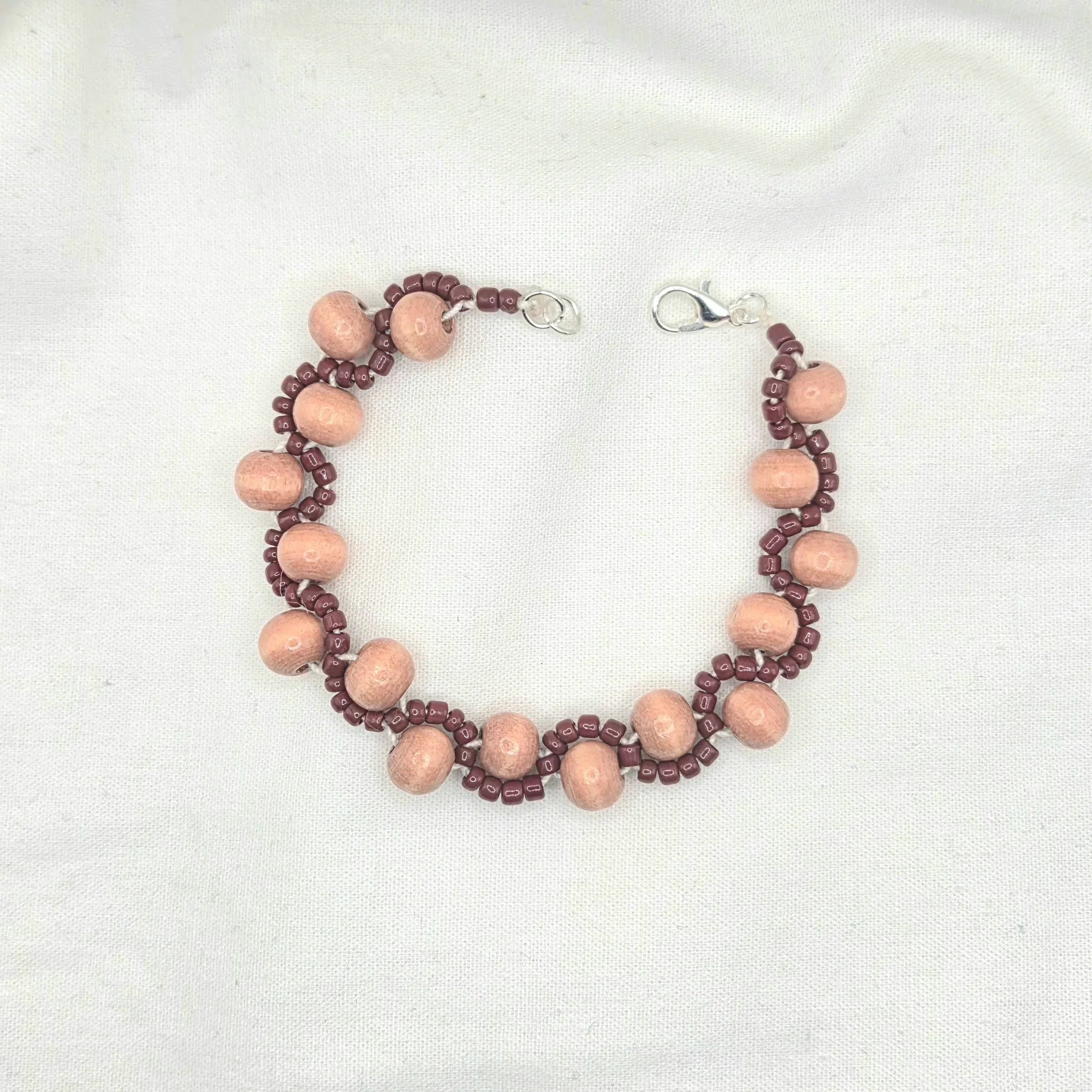 Handmade wooden bead necklace with burgundy accents and silver clasp, cozy artisan jewelry