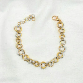 Gold and silver interlocking chain necklace on white fabric, elegant handmade jewelry piece