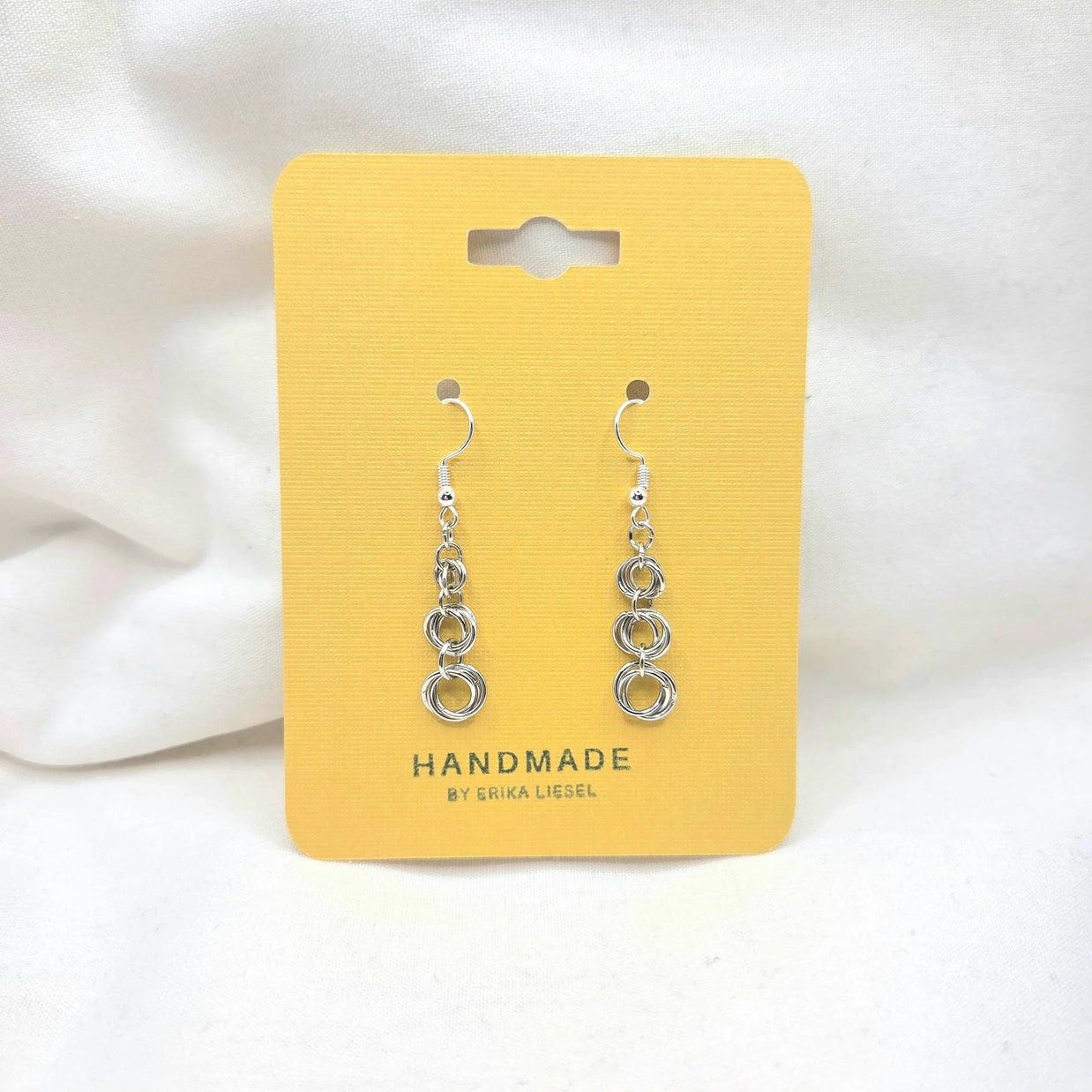 Handmade silver chain link dangle earrings on yellow display card, artisan crafted jewelry gift
