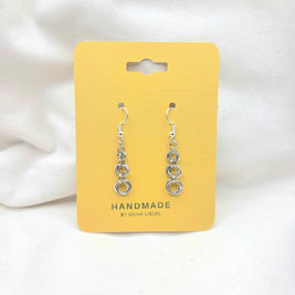 Handmade silver chain link dangle earrings on yellow display card, artisan crafted jewelry gift