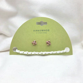 Handmade copper stud earrings with white crochet chain on green card, cozy artisan jewelry gift