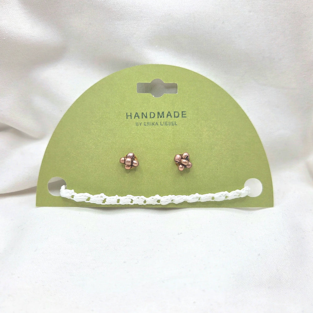 Handmade copper stud earrings with white crochet chain on green card, cozy artisan jewelry gift