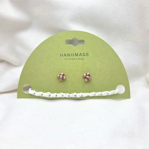 Handmade copper stud earrings with white crochet chain on green card, cozy artisan jewelry gift